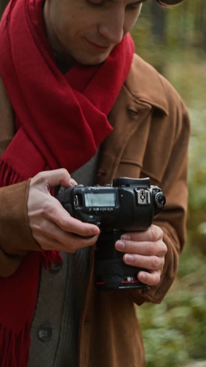 Man with Camera in Autumn Forest