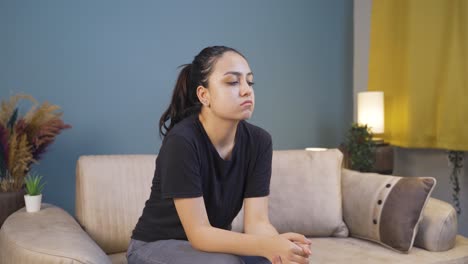 depressed young woman alone at home.