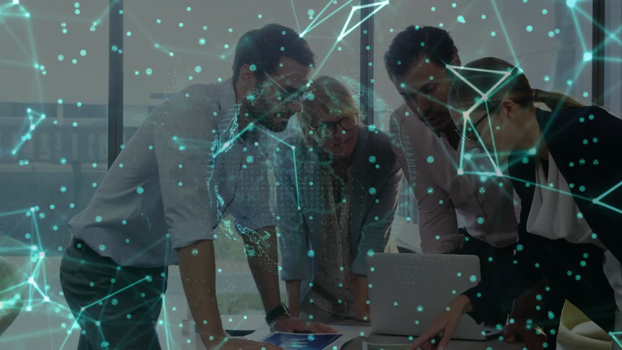 Senior woman with business team tapping tablet causing rotating globe overlay while reviewing docs