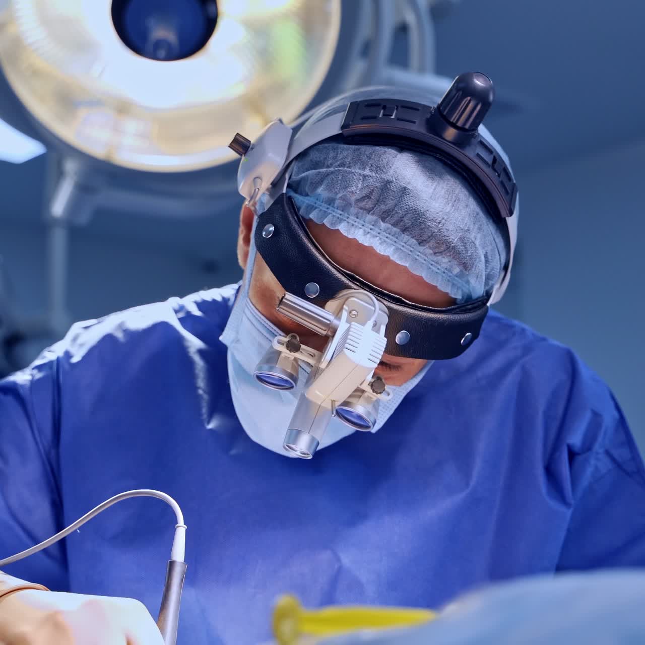 Hard-working neurosurgeon wearing device glasses performing procedure. Doctor applies the instrument at work