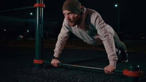 man doing push-ups at night