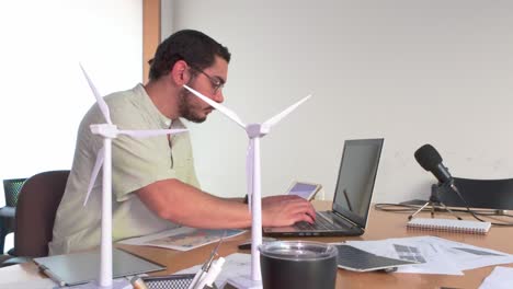focused architect reviewing blueprints for a wind farm development