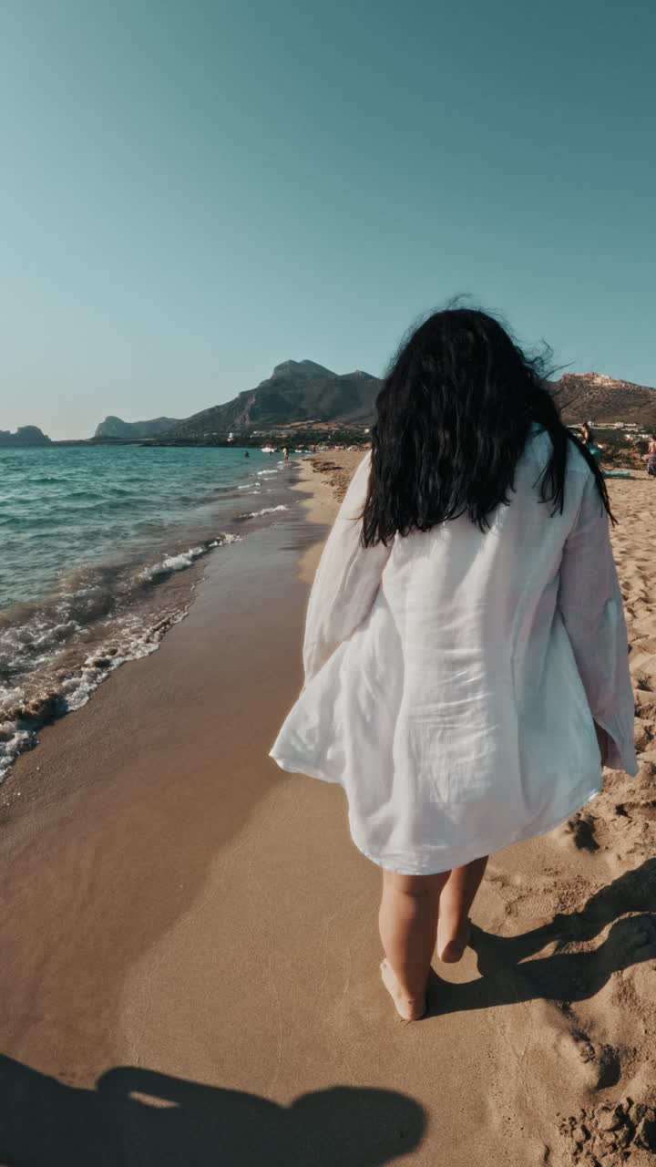 Woman Walking On The Scenic Beach - Falassarna Beach, Crete, Greece - Vertical Shot