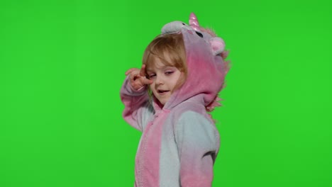 Little-blonde-child-girl-smiling,-dancing,-celebrating-in-unicorn-pajamas-costume-on-chroma-key