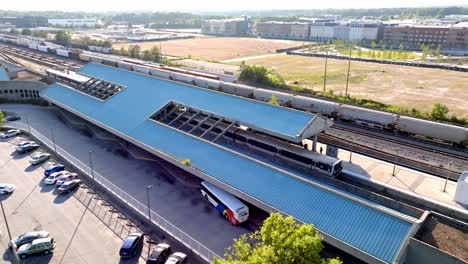 marta train arriving at doraville subway station, new peachtree road, third rail studio in background, atlanta, georgia, drone shot