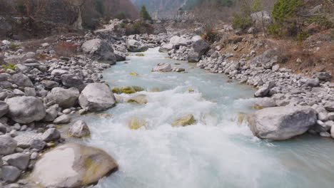 drone view of dudh koshi river flowing freely at high altitude nepal with boulders and spiritual significance, scenic trail for tourist travel experience in nepal, peace and calm