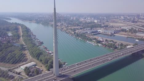 Slow-4k-tilting-shot-of-Ada-bridge-in-Belgrade-and-New-Belgrade,-aerial-drone