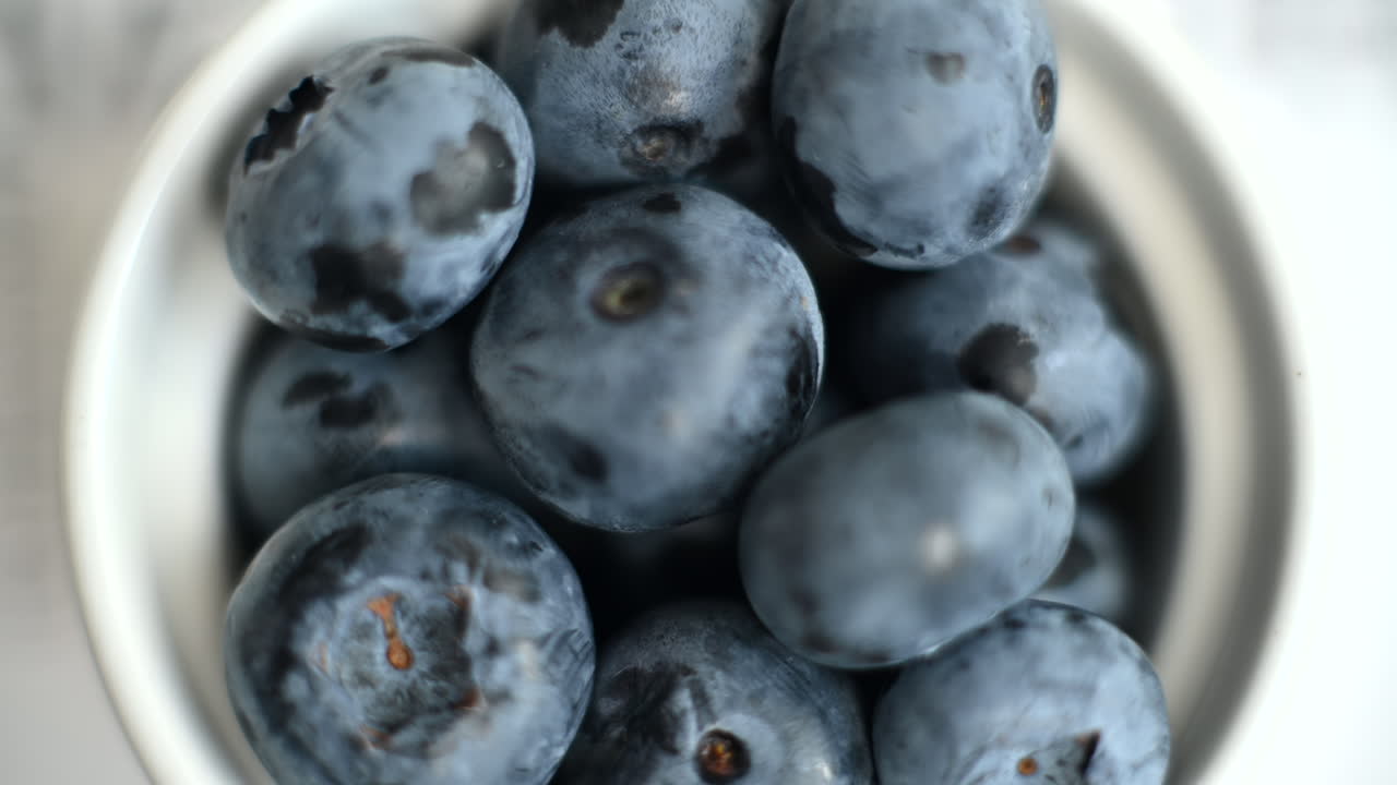 Close up of a bunch of blueberries in a white bowl