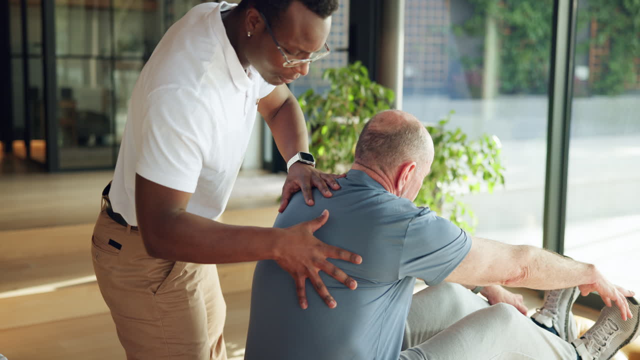 Physical Therapist Assisting Senior Man with Stretching Exercise