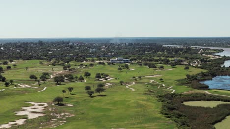 a drone advancing over a beautiful golf course in latin america, showcasing lush greenery and scenic landscapes