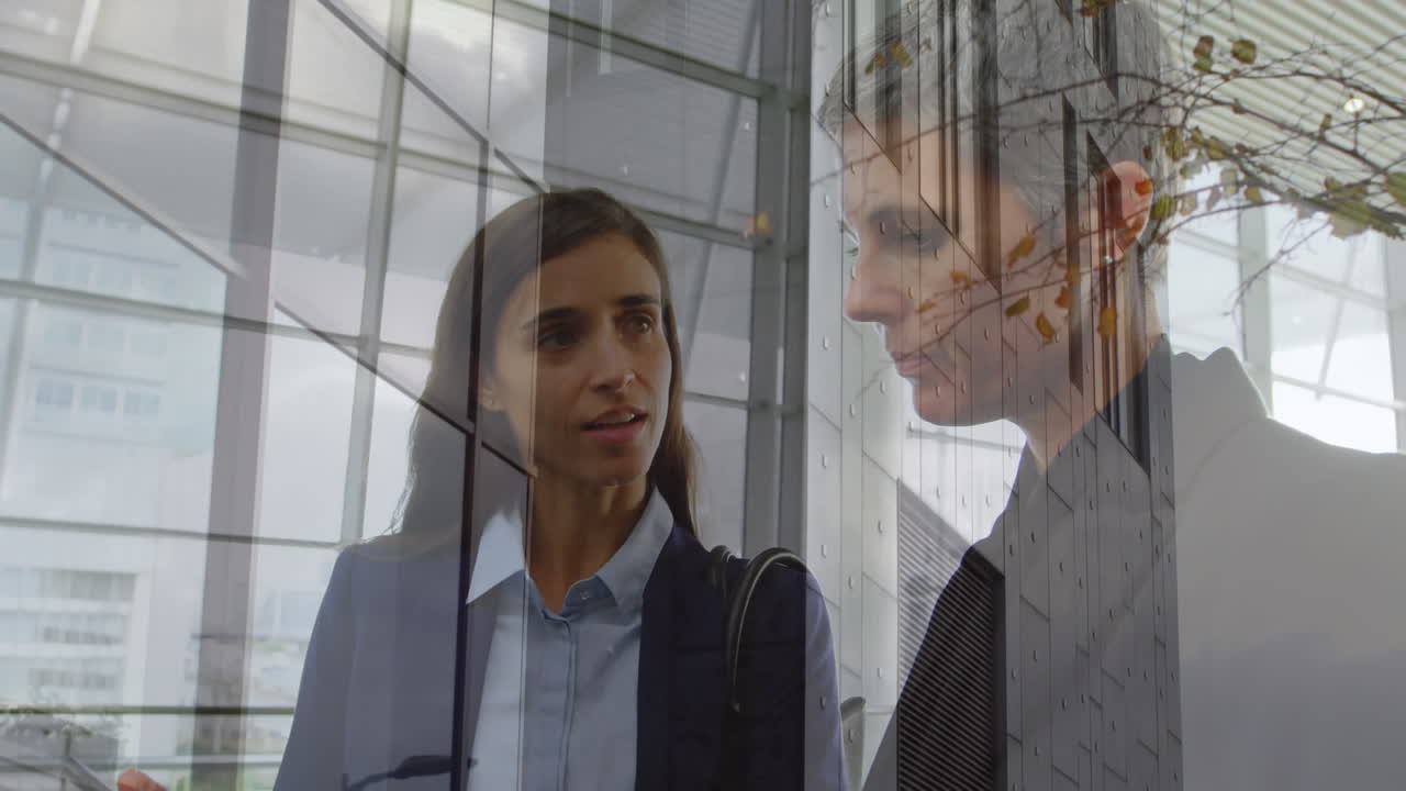 Animation of office building over business people talking in modern office
