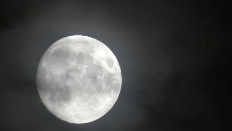 full moon moving left to right on a cloudy night