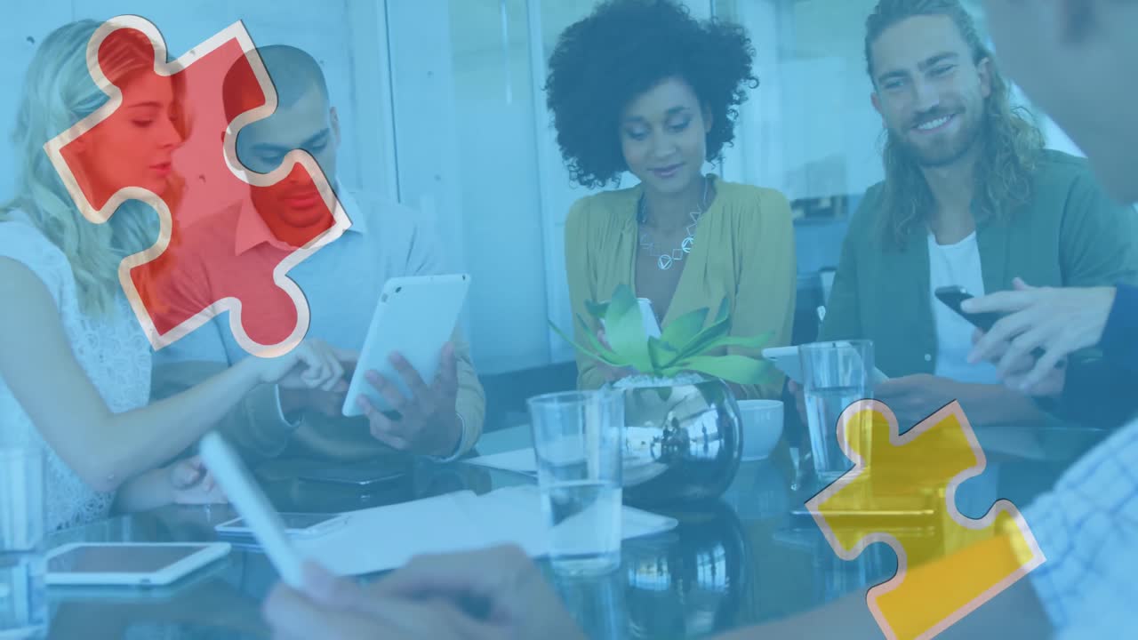 Animation of colourful puzzle pieces over business colleagues using tablets