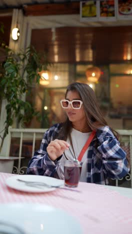 woman enjoying tea at an outdoor cafe