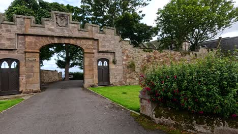 stone archway with lush greenery and sky