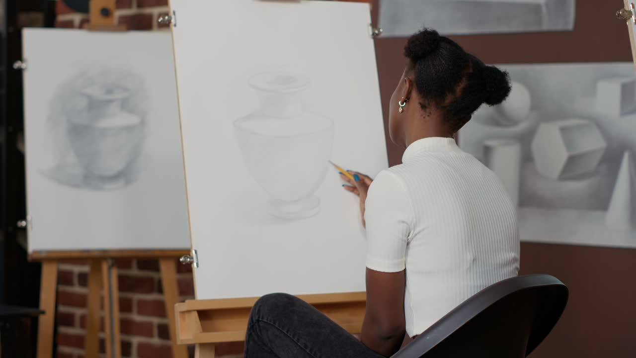 Young woman learning to draw vase sketch on paper