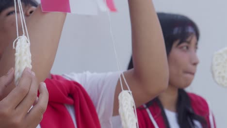 group of young asian people prepares for crackers eating competition to celebrate indonesian independence day