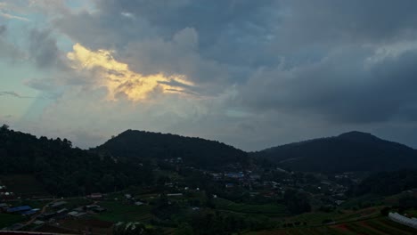 mountain village at sunset with dramatic clouds
