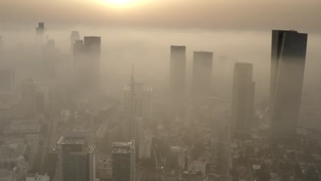 foggy sunrise over city skyline