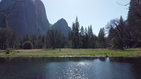 fresh spring snowmelt in the subalpine meadows of yosemite national park, california, usa. granite mountain backdrop towering above the valley floor.