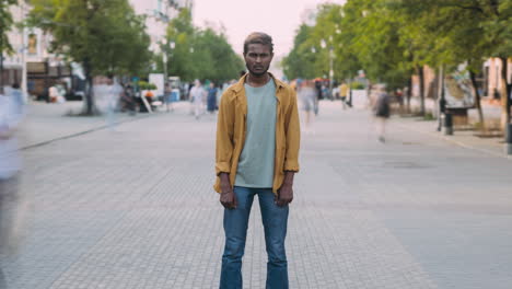 man standing in the city street