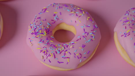 pink glaze donuts on a pink background