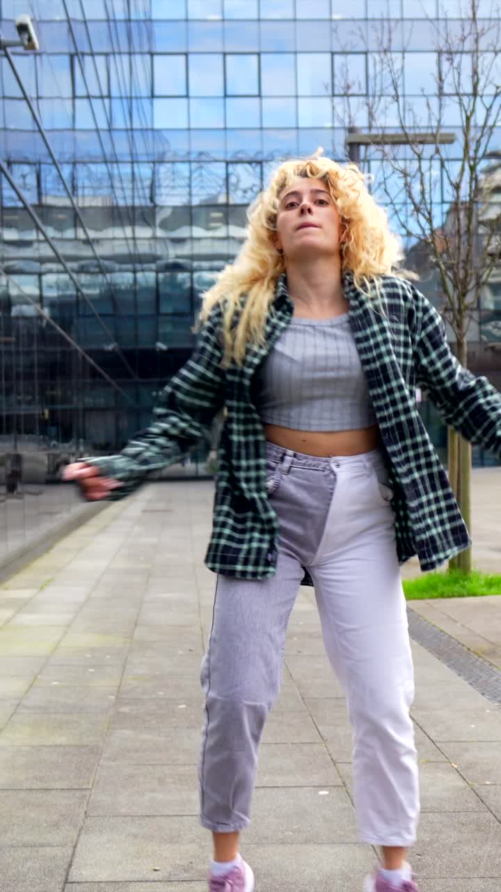 Woman Dancing in Front of Building