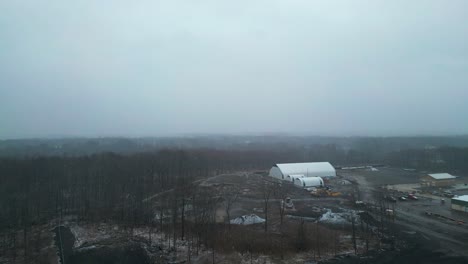 An-aerial-view-of-a-neighborhood-during-a-snow-storm-rolling-in