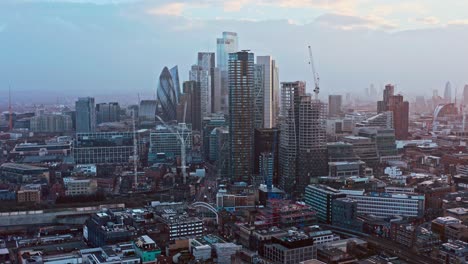 aerial drone shot of skyscrapers in city of london from shoreditch highstreet at sunset