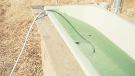 Hot-Tub-Being-Filled-With-Water-Outdoors---Close-Up