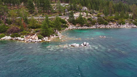 Aerial-view-around-the-rocky-coast-of-Lake-Tahoe,-cloudy-day-in-California,-USA