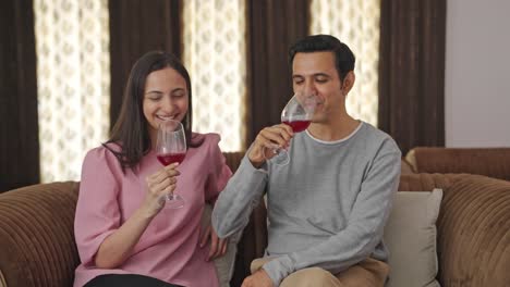 newly married indian couple drinking wine and enjoying