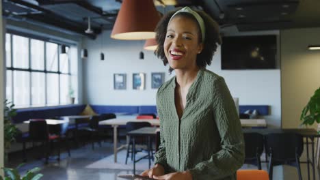 Portrait-of-happy-african-american-businesswoman-looking-at-camera-at-office