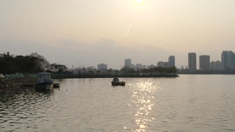 vessels moored along the lake’s edge, adding to sunset picturesque scene