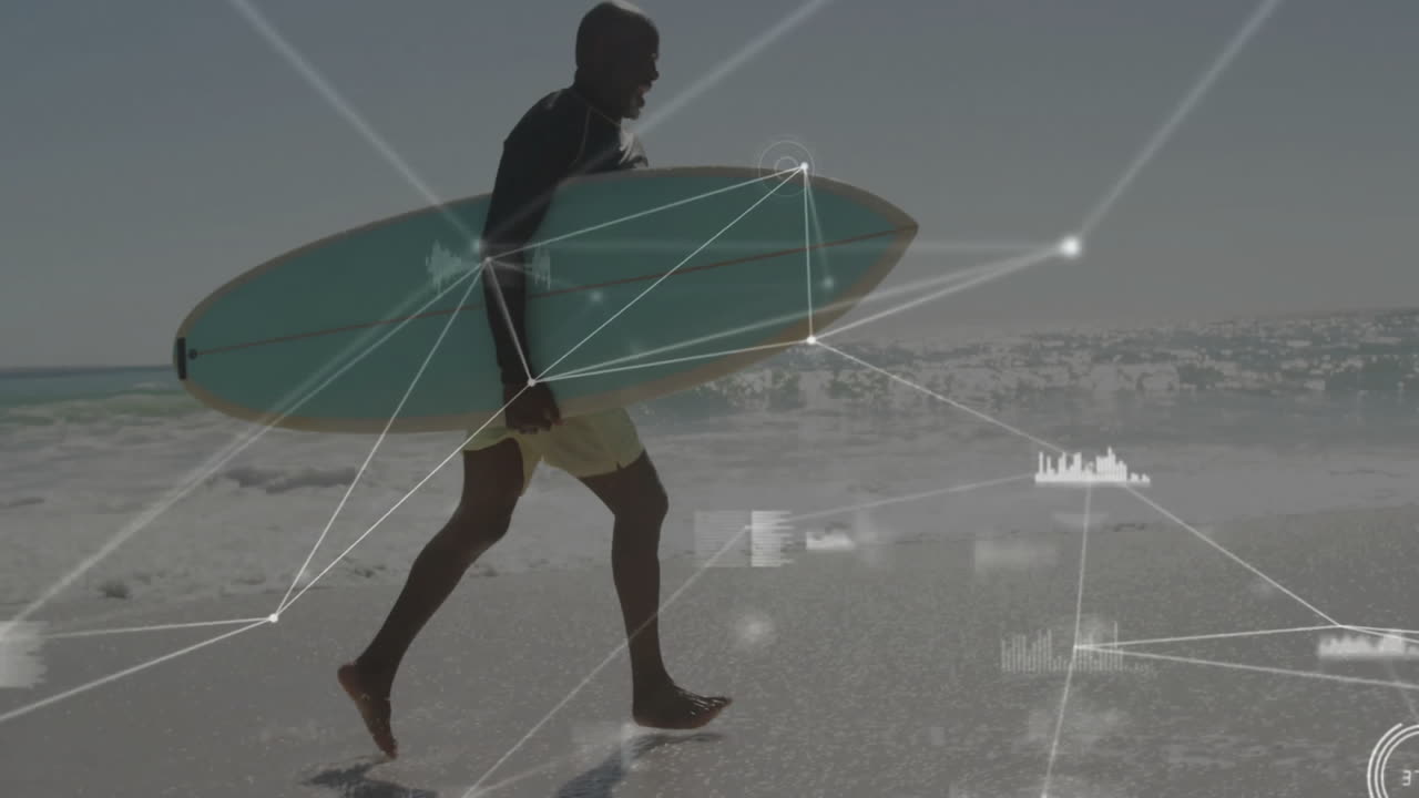 Man carrying surfboard walking on beach at water edge, featuring digital technology network overlay