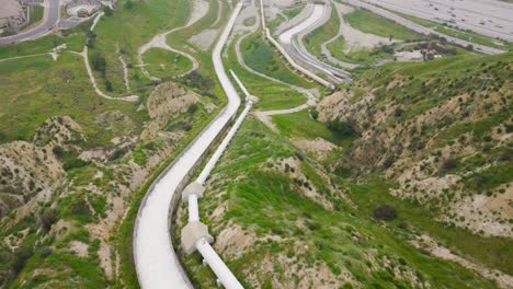 aerial drone time lapse tracking motion of water being released into the city to prevent flooding and ending drought and water restriction from the los angeles aqueduct cascades