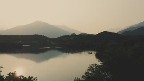 Sunset-reveal-shot-of-Lake-Sirio-near-morainic-town-of-Ivrea