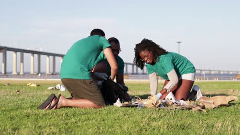 happy volunteers gathering trash