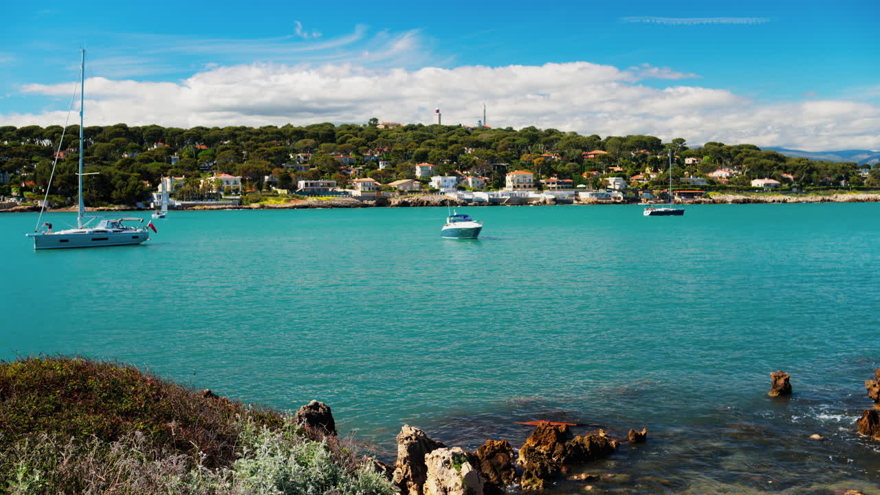 View of boats floating on the sea with the town of Bandol, France on the background