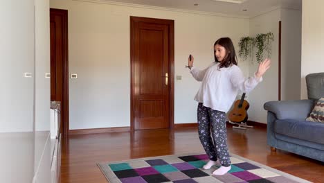 little girl dancing with virtual console video game