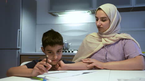 close-up view of mother and son in the kitchen