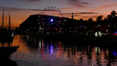 ferris wheel turning at sunset.