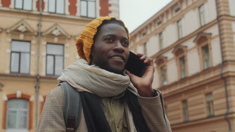 black male tourist chatting on phone in old town