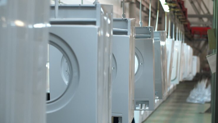 White washing machine moving on conveyor. Production household appliances