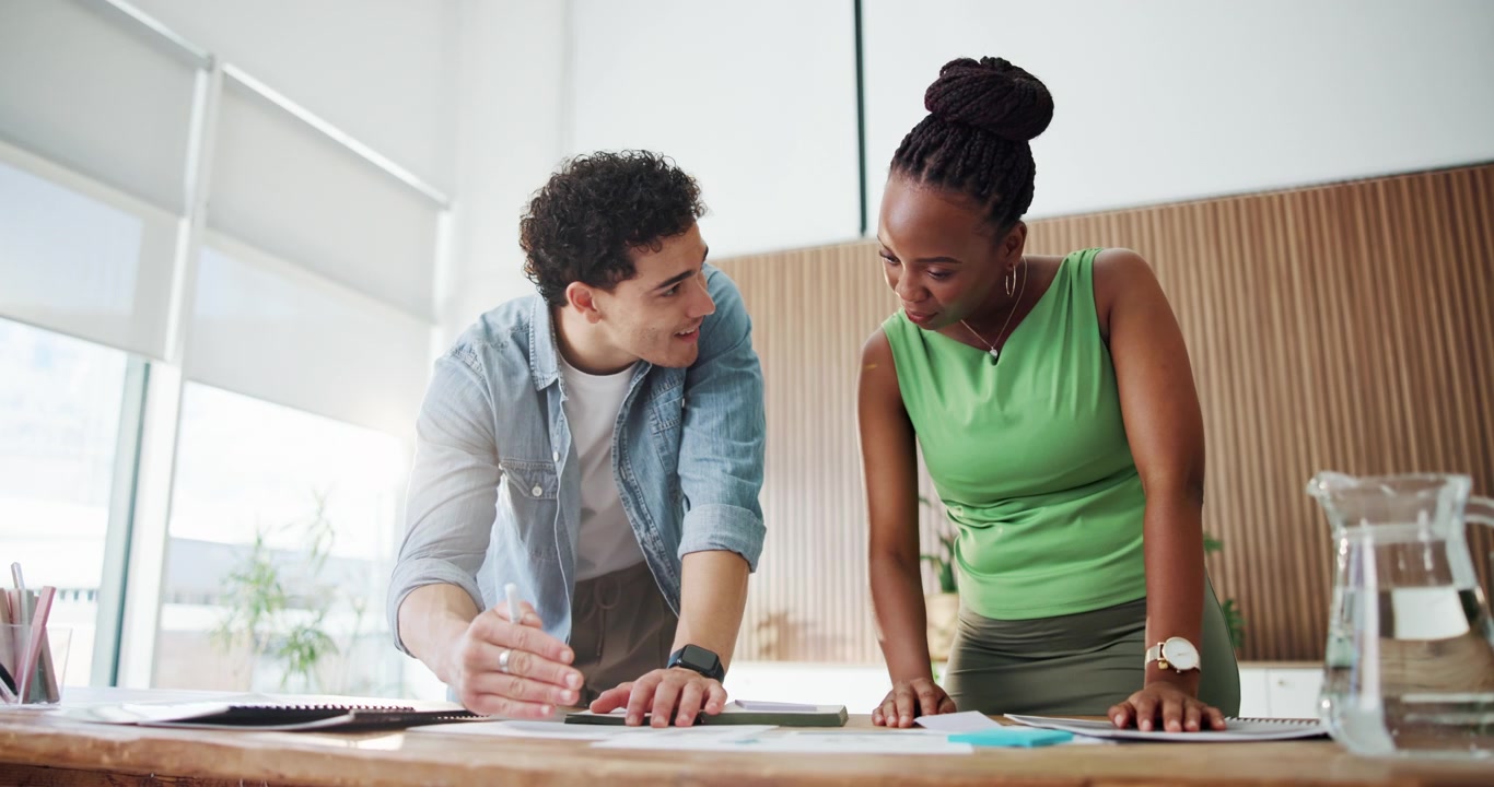 Diverse Colleagues Collaborating on Project at Office Desk