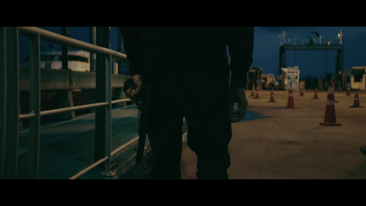 Man walking at night on a pier