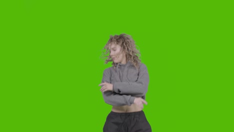 Studio-Shot-Of-Young-Woman-Having-Fun-Dancing-Against-Green-Screen-12