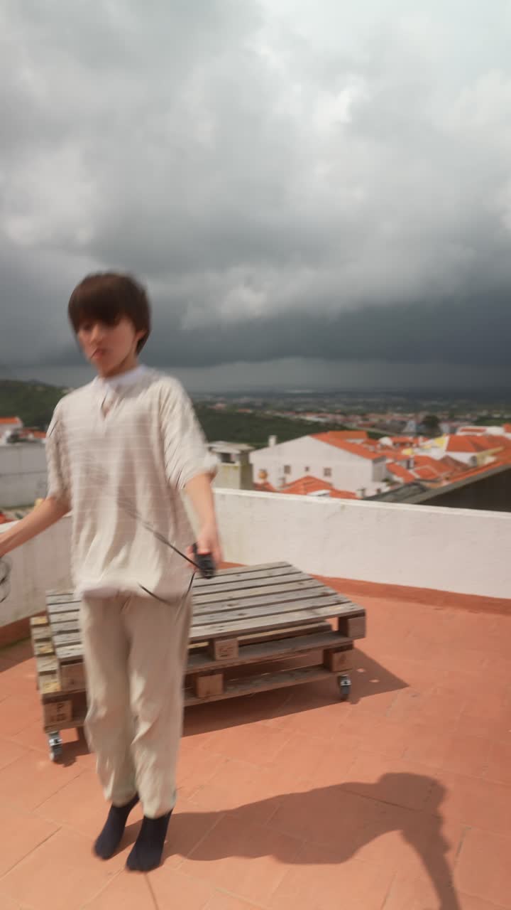 Boy skipping rope on rooftop