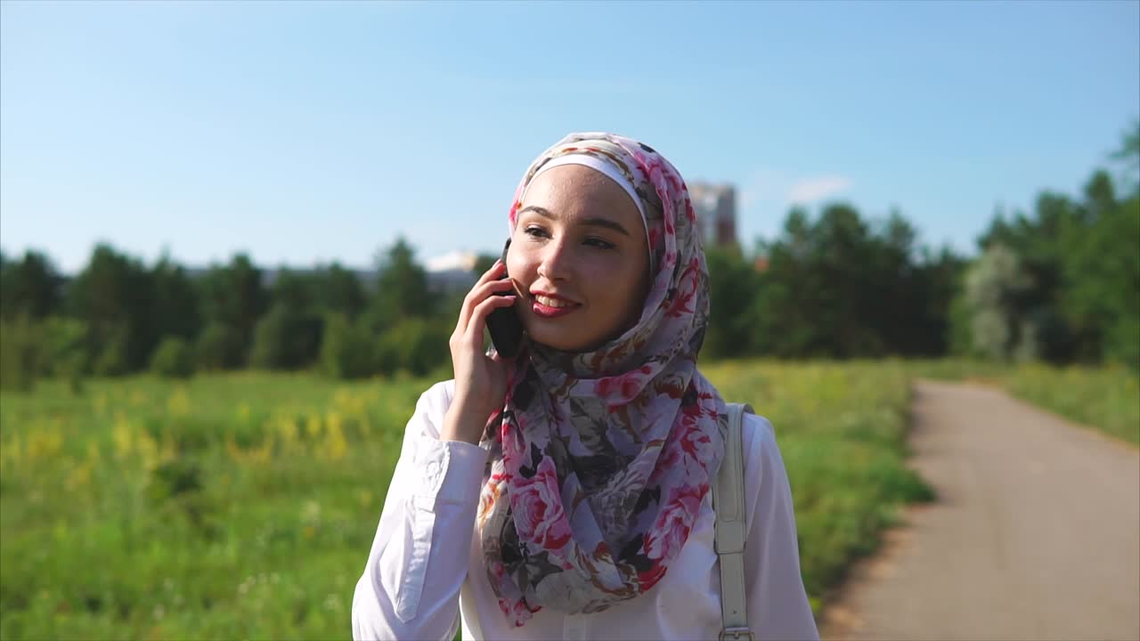 Young Woman Walking and Talking on Phone