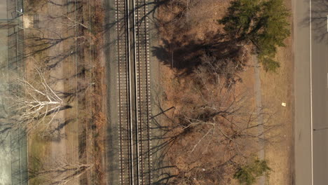 a top down shot of empty train tracks on a sunny day